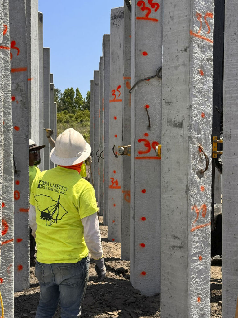 Worker inspecting piles